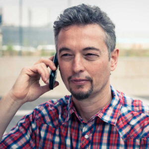 man with goatee on phone