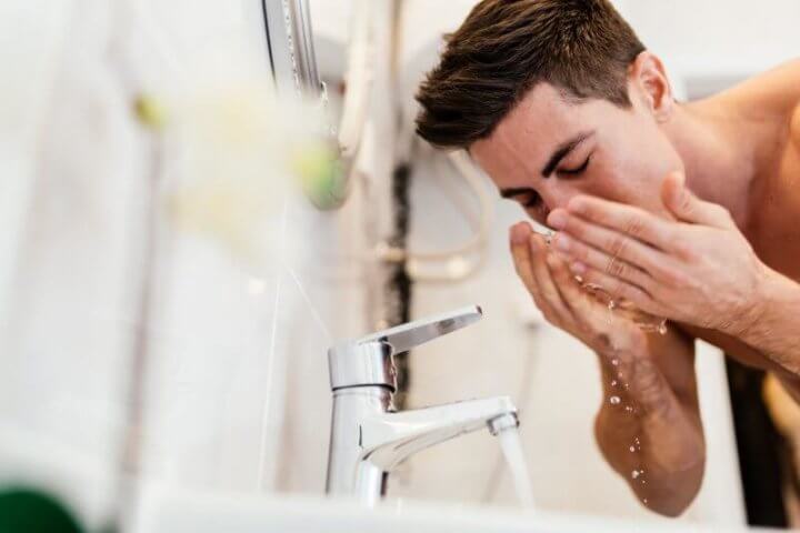 washing the face in preparation of traditional wet shaving