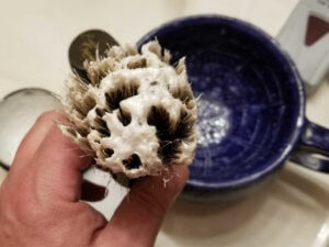 the art of shaving sandalwood shaving cream loading onto a semogue brush