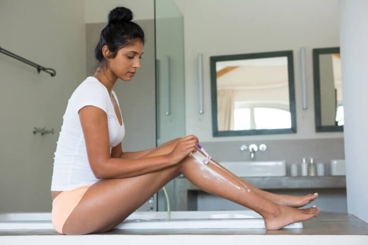 woman shaving legs