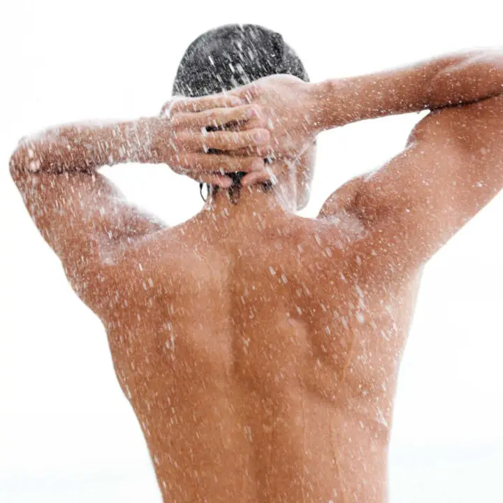 man showering back