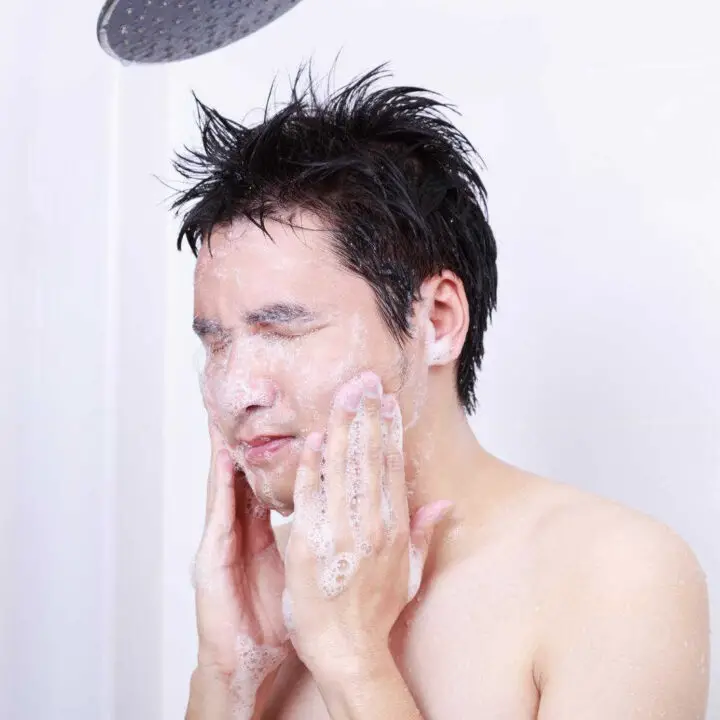 man washing face