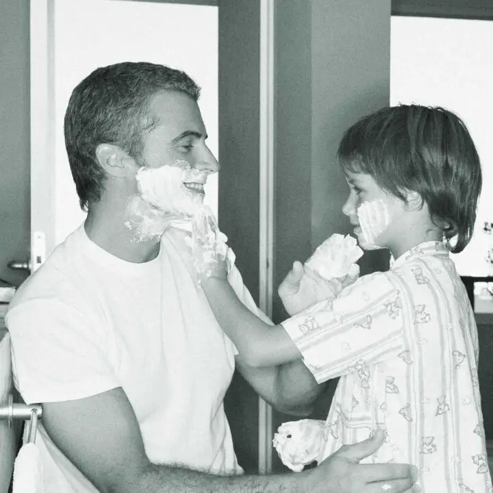 father and son applying shave lather