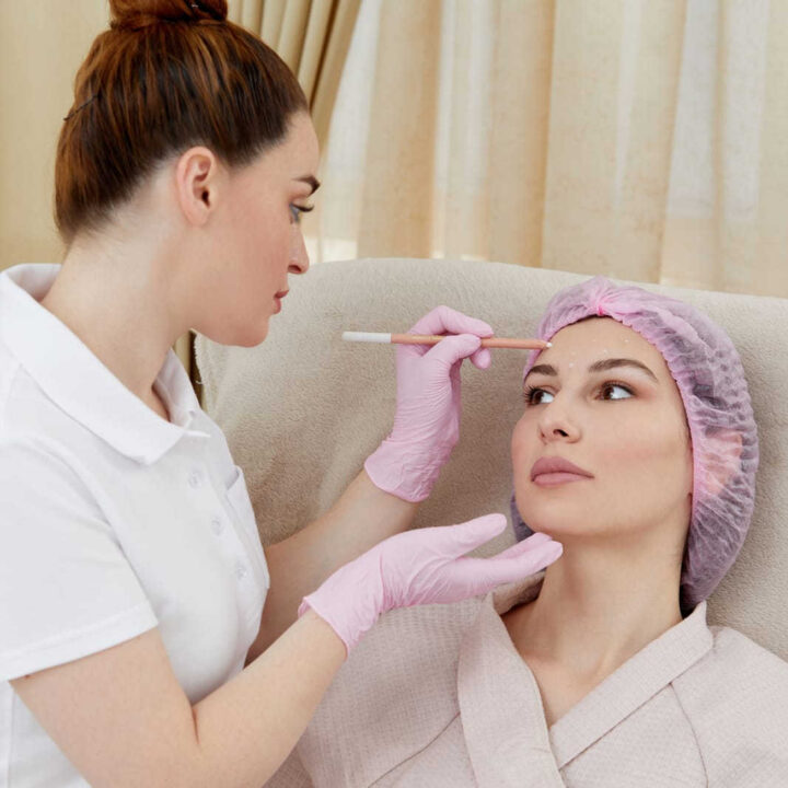 woman getting facial treatment exam