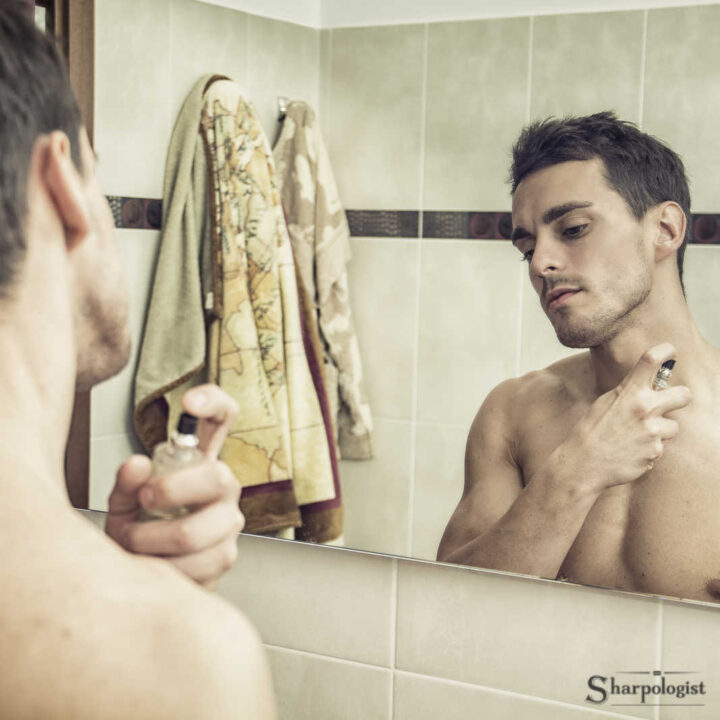 man applying cologne