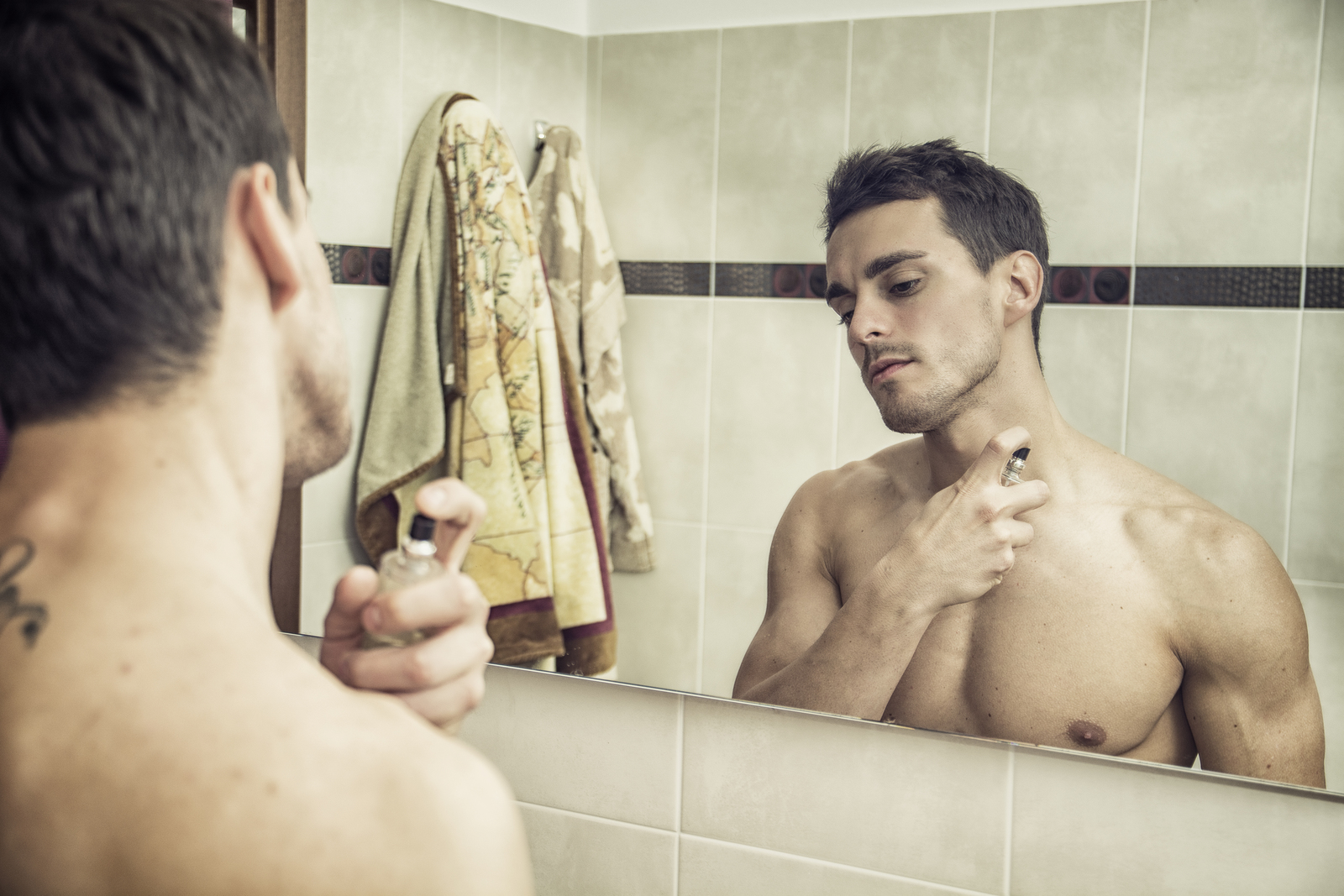 man applying cologne