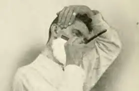 vintage image of man shaving with straight razor