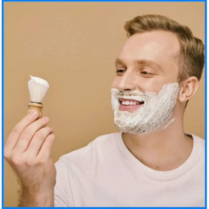 man holding shave brush