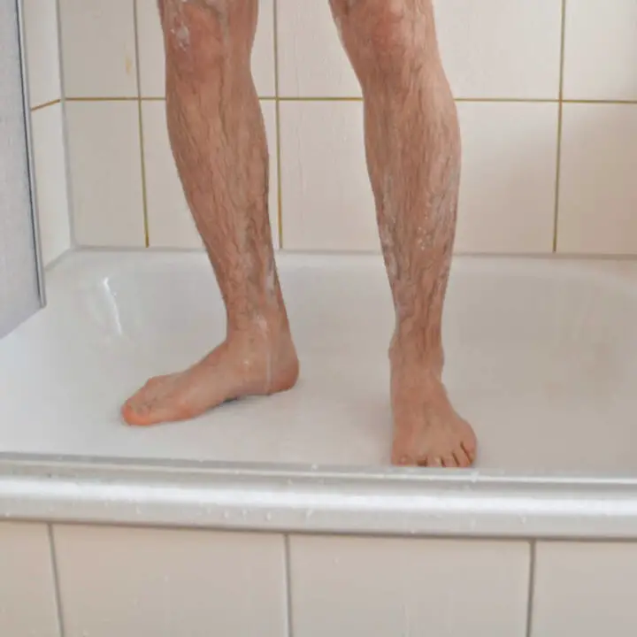 mans legs in shower