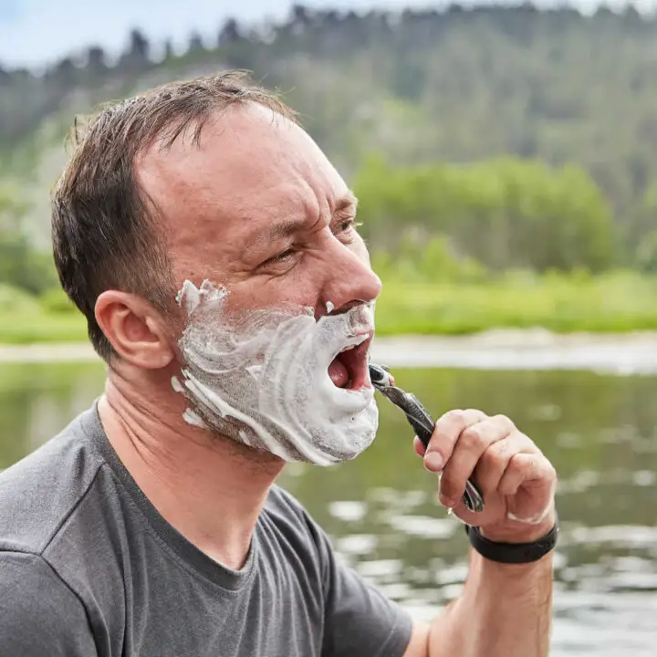 man shaving outside